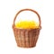 Wicker basket with yellow filler isolated on white. Easter item