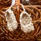 Wicker bast shoes on a wooden basket, Russian amulet