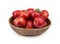 Wicker bowl of ripe juicy red apples with leaf on white