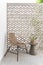 Wicker chair, exterior furniture, vintage terrace decor, concrete table and planter