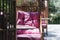 Wicker chair with pink pillows on a summer veranda in a cafe