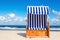 Wicker chair on sandy Kolobrzeg beach, Baltic Sea, Poland