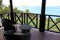 Wicker chairs and table on balcony overlooking gorgeous seascape