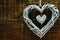 Wicker heart decoration on grunge wooden background valentine`s day concept