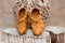 Wicker shoes of birch bark on a wooden tree stump