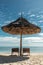 Wicker umbrella and sunbeds on paradise beach
