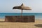 Wicker windbreak and umbrella on a beach beside the Red Sea