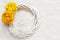 Wicker wreath decorated with yellow persian buttercup flowers (r