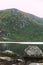 A Wicklow mountain next to a lake with some rocks