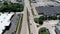 Wide Aerial drone shot suburban neighborhood. Trucks move along the road next to other cars