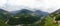 Wide aerial view of the alpine vineyards on a summer day. flat rows of fields, small village of Faver, famous for wine production