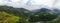 Wide aerial view of the alpine vineyards on a summer day. flat rows of fields, small village of Faver, famous for wine production