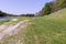 Wide ancient riverbed with a river on the left