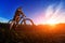 Wide angle of the cyclist standing on the trail on the field against beautiful landscape.