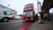 Wide angle ground level shot as a bus arrives at a bus stop on Euston Road outside of King`s Cross Railway Station and passengers