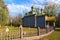 Wide-angle landscape view of ancient wooden cossack church with small cemetery in forest