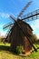 Wide-angle landscape view of ancient wooden windmill. Building of ancient Ukrainian village