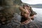 Wide angle macro shot of mating European toads Bufo bufo standing on rocky lake bottom partially submerged. Mountain la