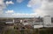 Wide angle overview at 100 metres height over the Rotterdam Skyline with blue sky and white rain clouds