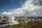 Wide angle overview at 100 metres height over the Rotterdam Skyline with blue sky and white rain clouds