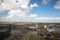 Wide angle overview at 100 metres height over the Rotterdam Skyline with blue sky and white rain clouds