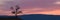 Wide angle panorama pink sunset,misty hills mountain tops in pink dawn