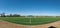 Wide angle panorama of a soccer field on a sunny day