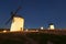 Wide angle shot of group of windmills in night