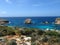 Wide angle shot of the Island of Comino in Malta under a blue sky