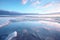 wide-angle shot of a lagoon with salt crystals reflecting the sky