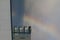 Wide-angle shot of modern architecture with a rainbow visible in the background