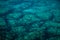 Wide angle shot of the stones underneath the ocean seen through the transparent water