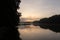 Wide angle view of a dock and reflection in the water on Lake Lanier in Georgia, USA at sunrise with clouds in the sky