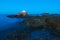 Wide Angle View of Moon over Seascape, Rocks and Lighthouse