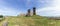 Wide angle view over the grass hill with Rocca of Radicofani fortress on top.