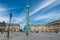 Wide angle view of Place Vendome square with blue sky.