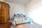 Wide angle view of a traditional English bedroom with patchwork quilts