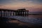 Wide angle view of the Tybee Island Pier in Georgia. Colorful sunset with pinks and purple colors in the sky