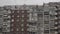 Wide apartment building close-up. Panoramic view of the building of the USSR against the background of gray clouds.