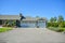 Wide asphalt driveway of residential house with three door garage attached