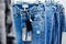 Wide assortment of jeans hanging in the store.
