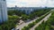 Wide avenue surrounded by trees crosses large city