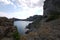 The wide bay is surrounded by high Crimean rocks covered with grass