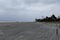 Wide beach with heavy surf and dark skies from an approaching storm