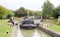 Wide beam narrowboat entering lock