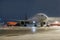 Wide body passenger airliner at the air bridge on night airport apron