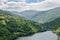 Wide calm river running through green forested hills in southern Bulgaria