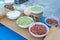 wide capture of taco condiment table showing bowls of cheese guacamole and pico de gallo