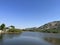 The wide and clear sky, the lake surface calm as a mirror with gentle ripples caused by the breeze