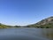 The wide and clear sky, the lake surface calm as a mirror with gentle ripples caused by the breeze